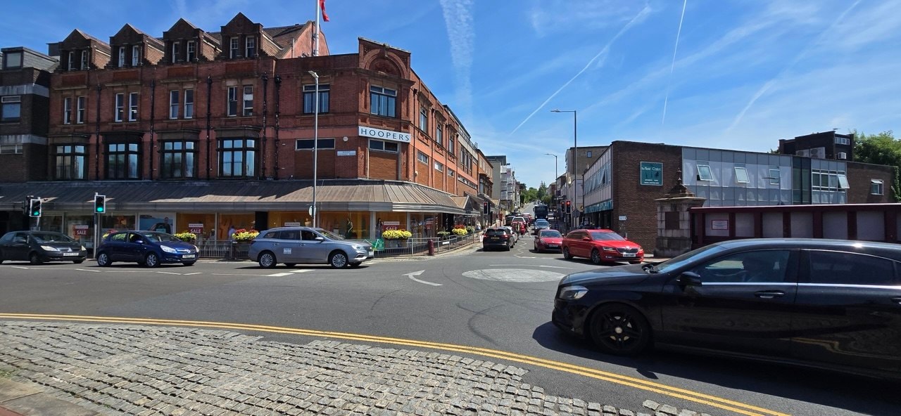 Tunbridge Wells town centre showing Hoopers department store and busy high street junction on a sunny day